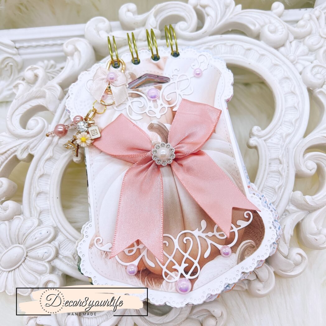 shabby chic pocket journal with blush satin bow, pearl brooch, white pumpkin artwork, ornate die-cut edges, gold-tone coil, pink heart pen, removable charm