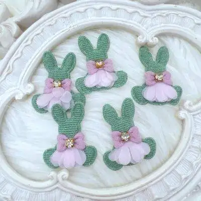 Fabric bunny appliques with mesh skirt and lavender bow featuring rhinestone center. Craft Supplies decor8yourlife store.