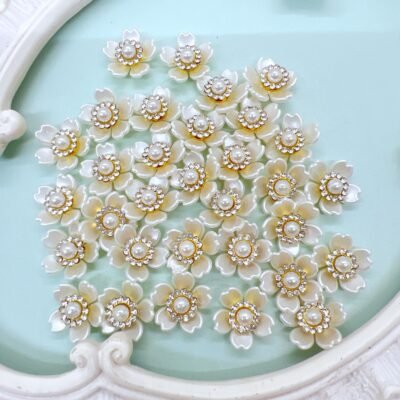 Cream color flower cabochons with rhinestone and pearl centers. Use these cabochon embellishments in diy crafts like bridal crafts, scrapbooks, shabby chic and vintage crafts, journals, mini albums, mix media, card making and more.