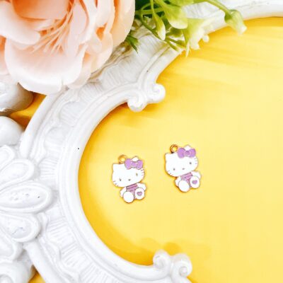 Shop officially licensed Hello Kitty enamel charms, sold as a set of two, approx. 3/4 inch. Perfect for beaded pens, jewelry making, keychains, planner charms, and kawaii craft projects.