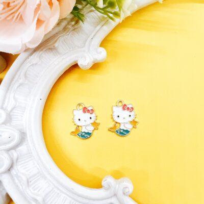 Shop officially licensed Hello Kitty enamel charms, sold as a set of two, approx. 3/4 inch. Perfect for beaded pens, jewelry making, keychains, planner charms, and kawaii craft projects.