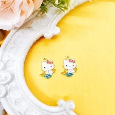 Shop officially licensed Hello Kitty enamel charms, sold as a set of two, approx. 3/4 inch. Perfect for beaded pens, jewelry making, keychains, planner charms, and kawaii craft projects.