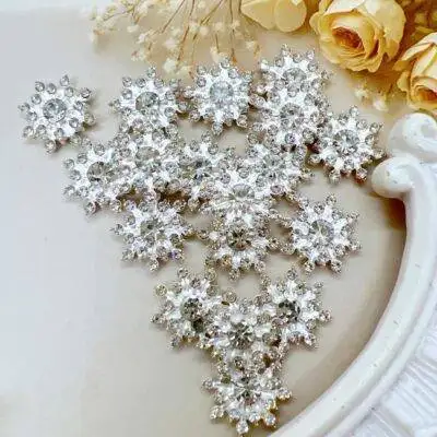 Silver alloy snowflake cabochon with rhinestone center. Level up your craft projects with embellishments from craft store decor8yourlife.