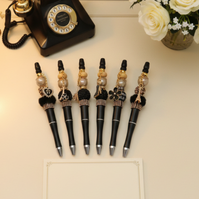 Luxury black and gold Paris theme, black ink pens with beads and charms.