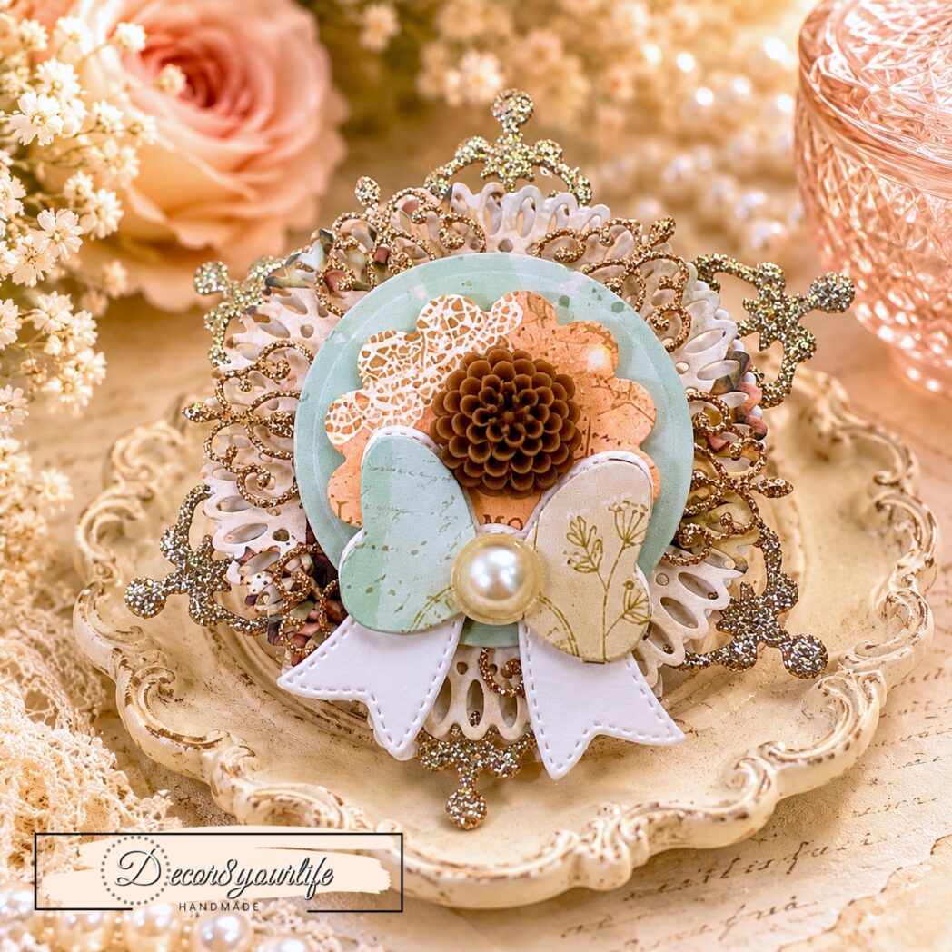 Handmade layered paper rosette embellishment created with circle dies, decorative frame dies, glitter cardstock, watercolor paper, and papers from the Honey Bees & Summer Breeze scrapbook collection by Decor8yourlife.