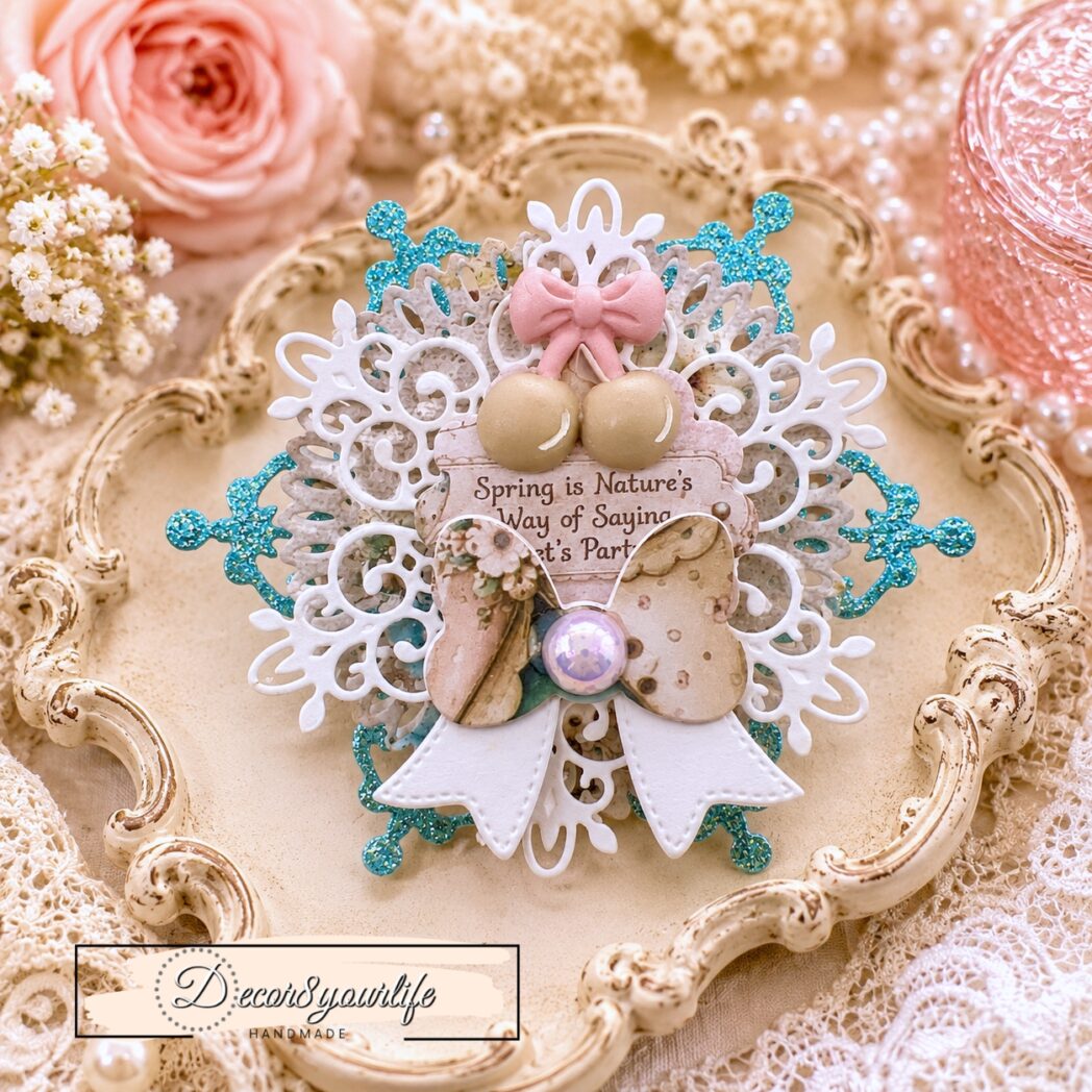 Handmade layered paper rosette embellishment created with circle dies, decorative frame dies, glitter cardstock, watercolor paper, and papers from the Honey Bees & Summer Breeze scrapbook collection by Decor8yourlife.