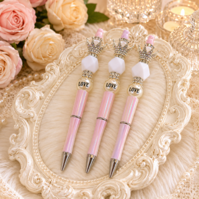 Luxury handmade blush pink iridescent refillable beaded pen with silver crystal crown topper, white faceted acrylic bead, LOVE pearl accent, rhinestone spacers, polished silver hardware, and pearl-inspired design by Decor8yourlife.