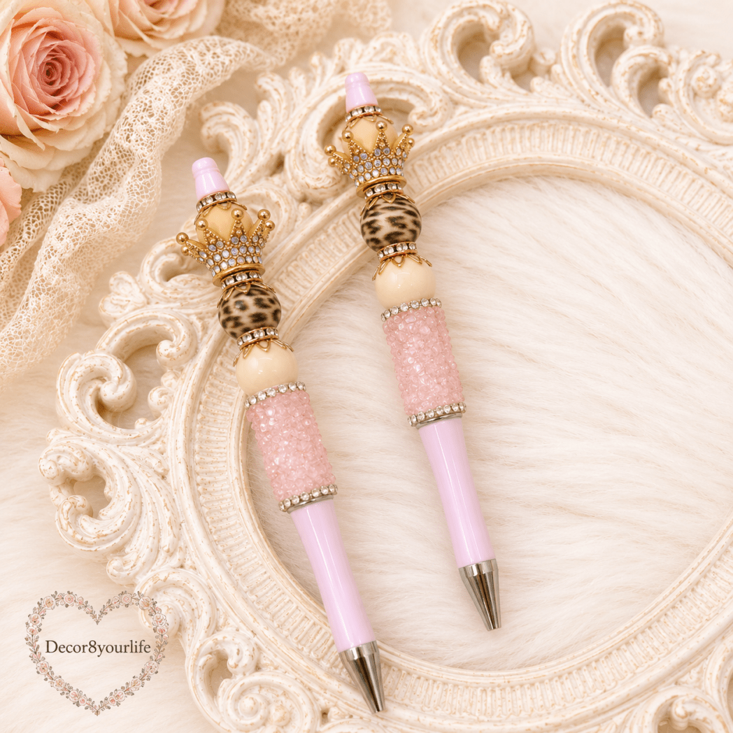 Handmade pink beaded gift pens with silver jeweled crowns, iridescent pearl beads, and blush pink barrels by Decor8yourlife displayed on an elegant vintage styled background.