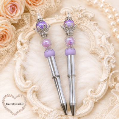 Luxury silver handmade beaded pens with champagne pearl beads, crystal crown toppers, and elegant writing accessories by Decor8yourlife displayed on a romantic vintage background.