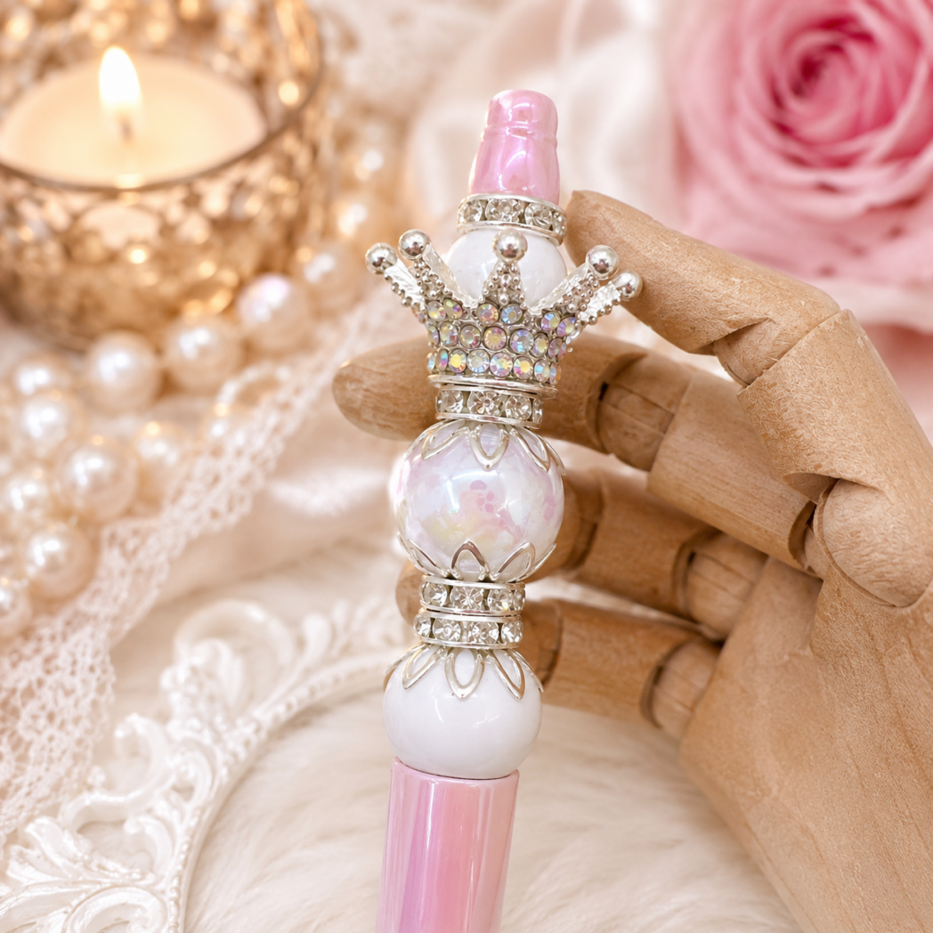 Close-up of a handmade luxury pink beaded pen featuring PandaHall crown toppers, rhinestone spacers, blush beads, and sparkling crystal accents, handcrafted by Decor8yourlife.