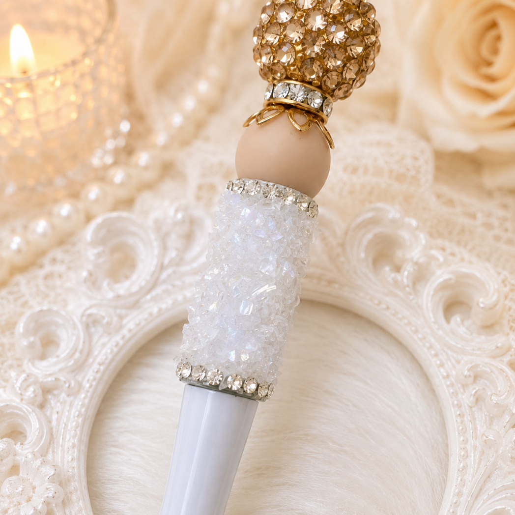 Close-up of a luxury handmade beaded pen featuring textured white crystal bead, gold crown topper, rhinestone spacers, and elegant ivory bead accents using PandaHall beadable pen components.